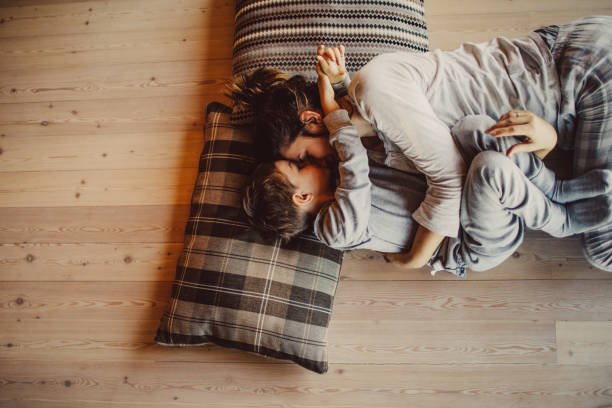 Mother and child on a hardwood floor in a family home